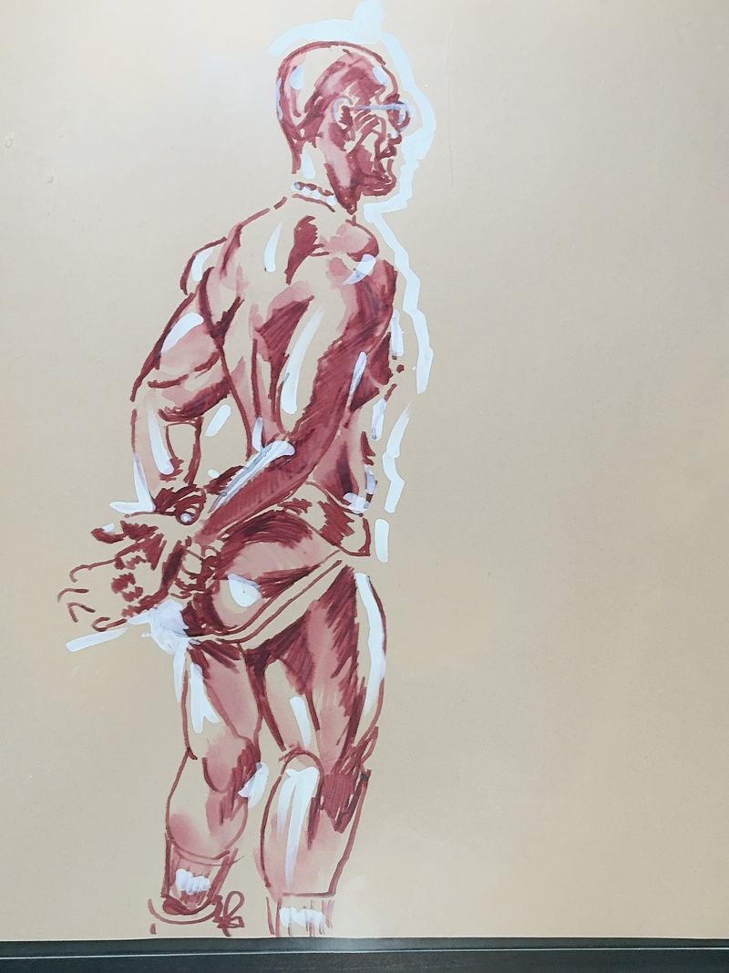 Felipe standing with hands behind back wearing a jockstrap