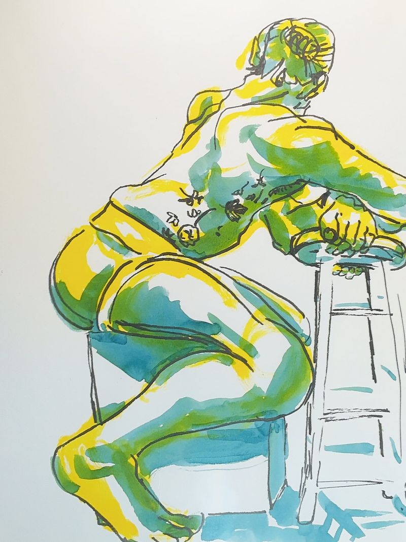 Male figure crossing arms while seated on a stool.