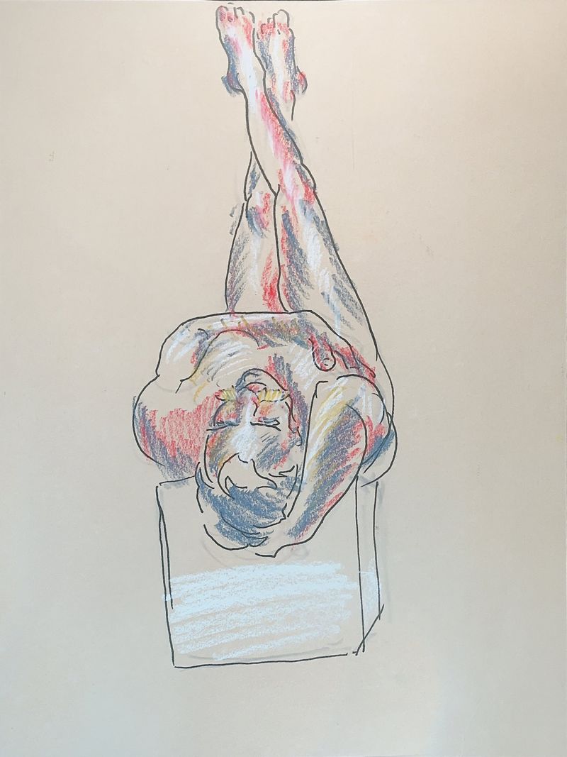 A male model with legs raised against the wall is captured in pastel pencil on toned paper.
