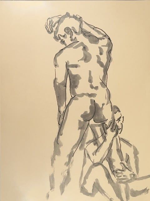 A man leans on the wall while another grabs his leg